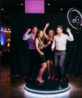 Guests dancing on the 360 photo booth platform with ring light